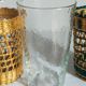 Four long drink glasses in vintage woven rattan cases
