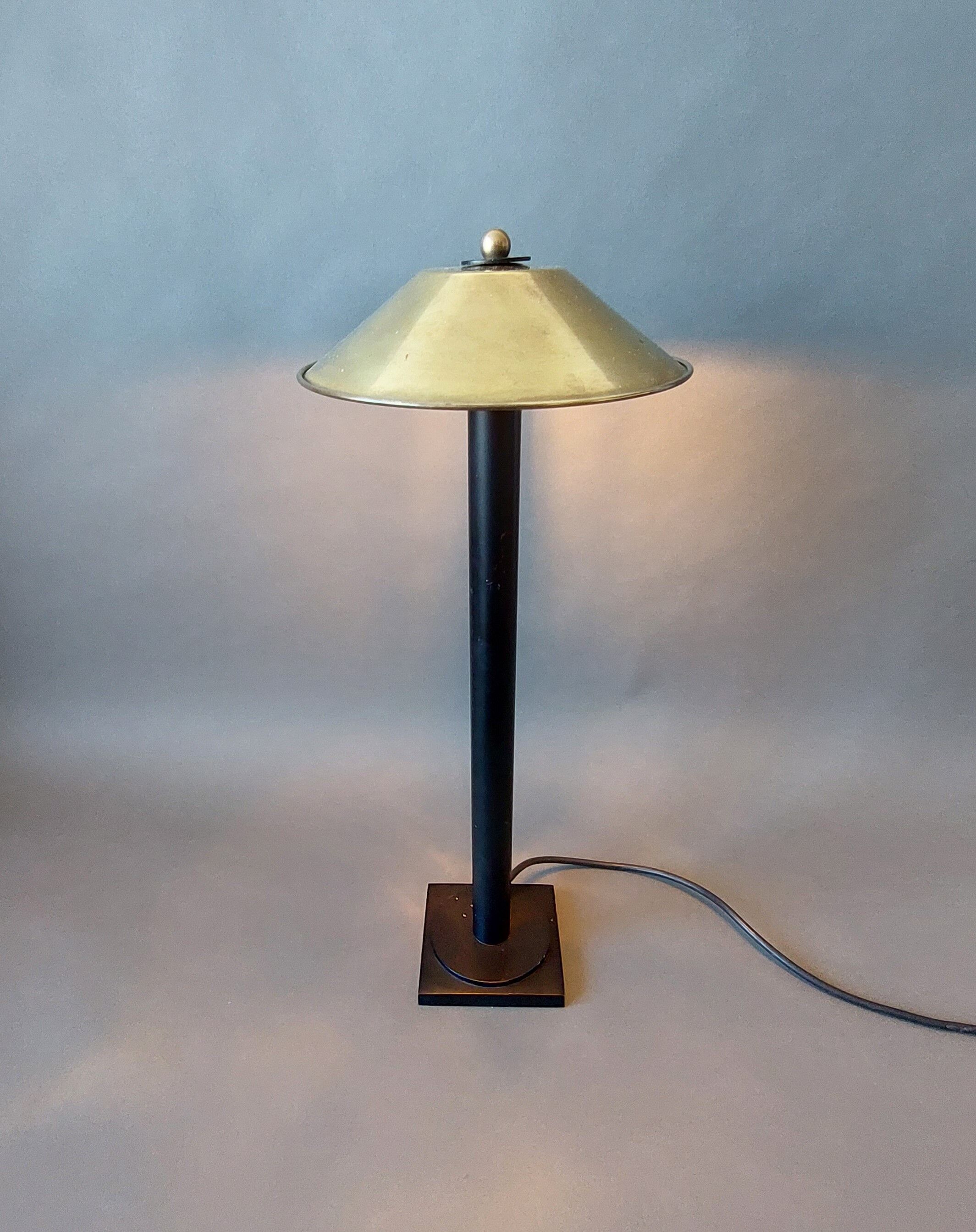 Post-Modern lamp in black metal and gilded brass.