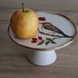 Cake display on pedestal with bird decor