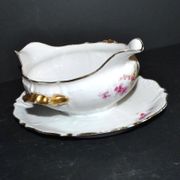 Vintage pouring sauce boat in floral porcelain with gilding.