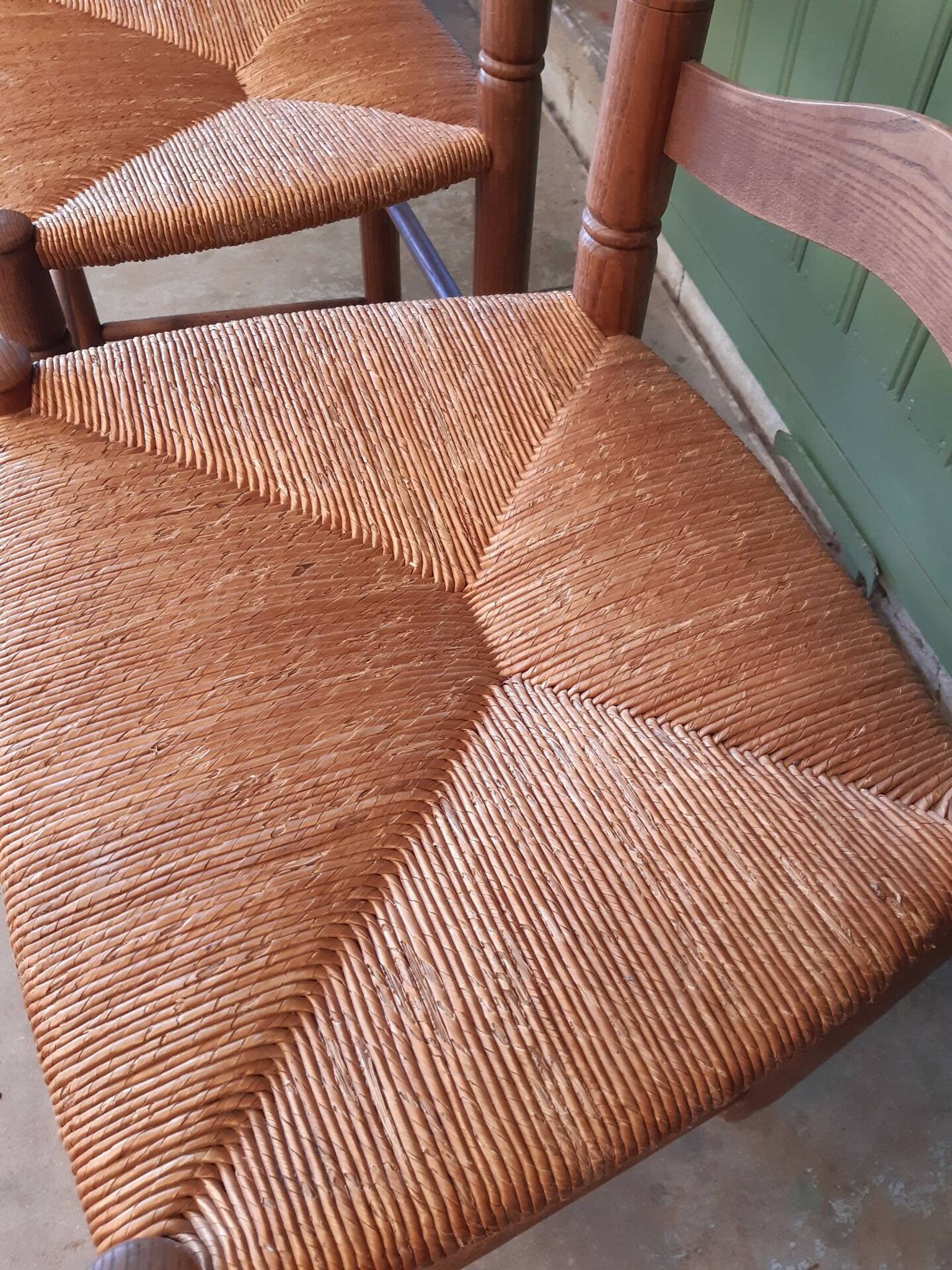 Pair of country-style straw chairs.