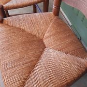 Pair of country-style straw chairs.