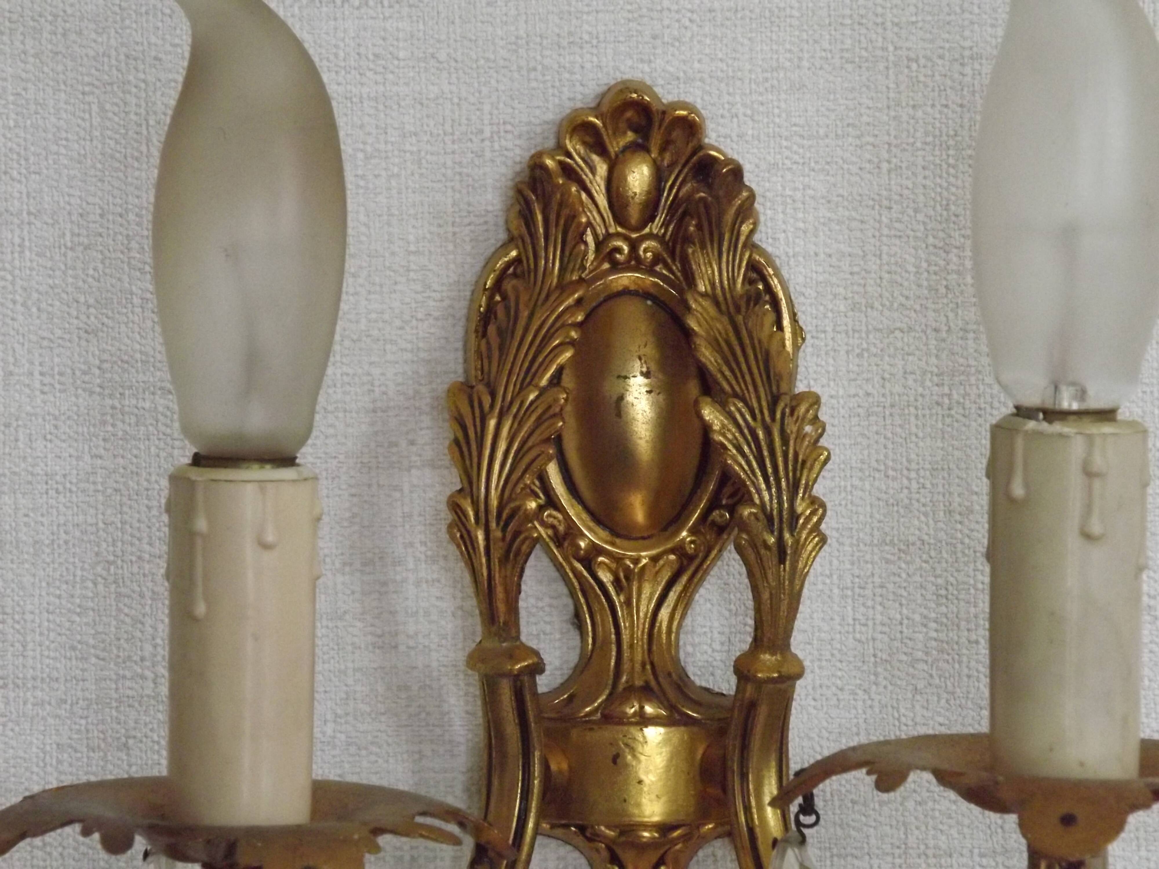 Pair of antique 2-light wall sconces in bronze with crystal pendants, Spain.