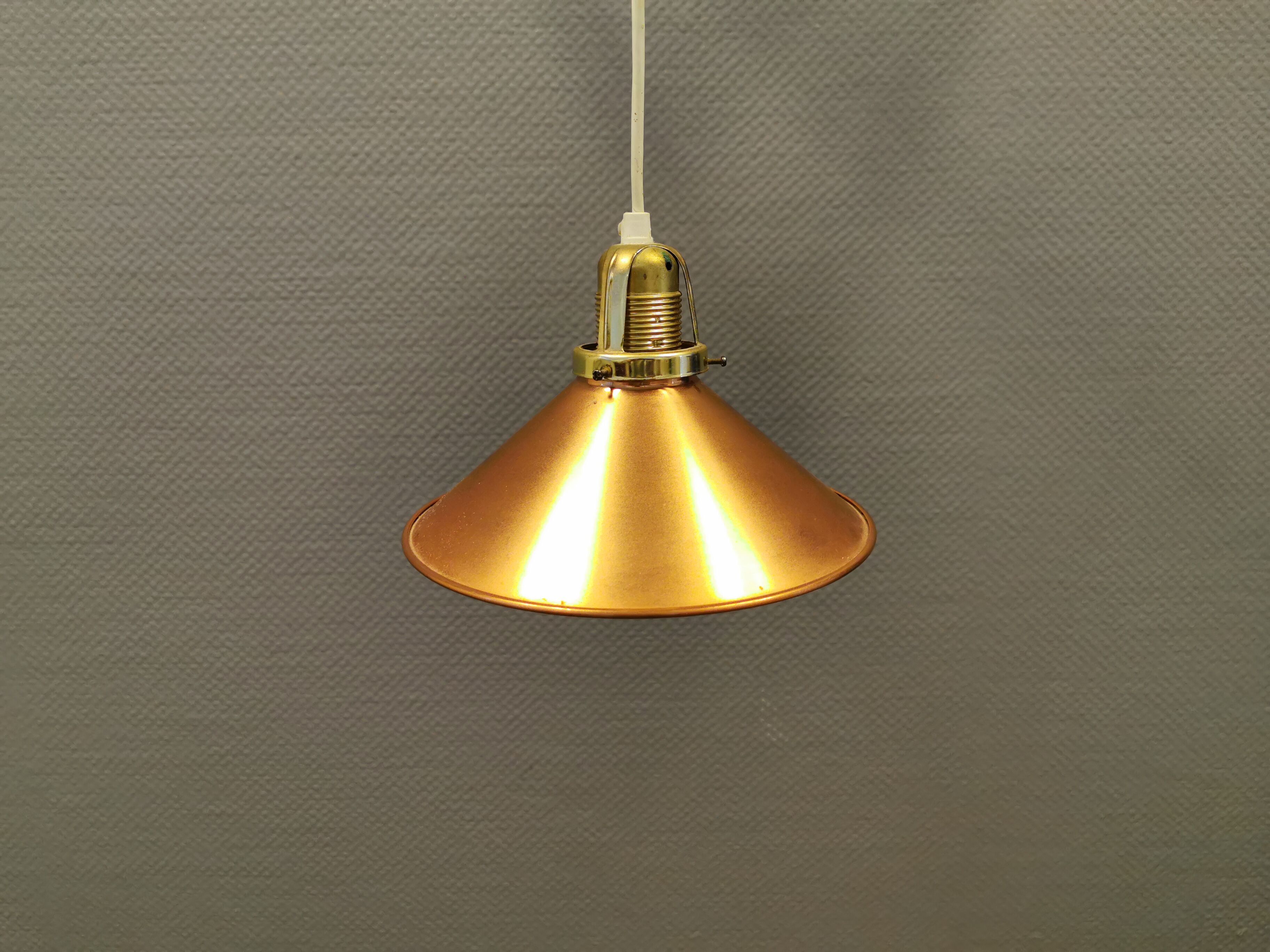 Copper hanging lamp with brass colored top and white inside lacquer.