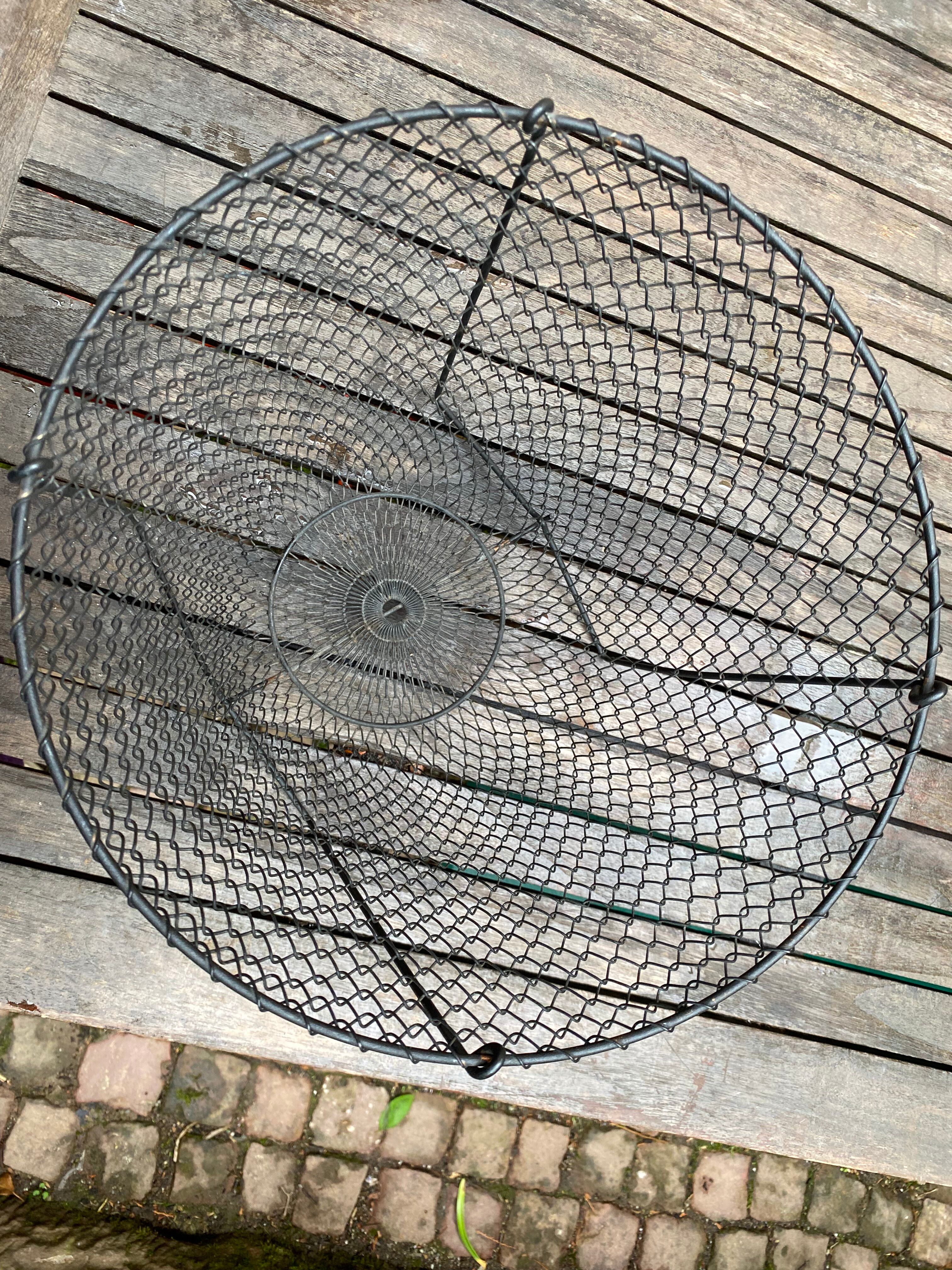Foldable black woven metal wastepaper basket from around 1950.