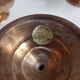 Set of four copper candlesticks in the shape of lotus flowers