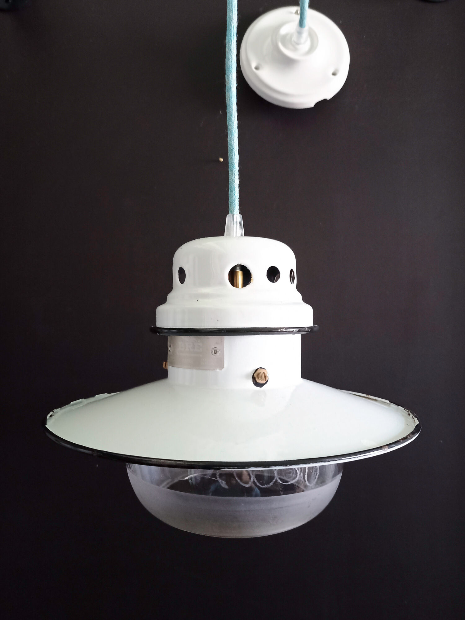 Old enamelled sheet metal suspension with glass cup