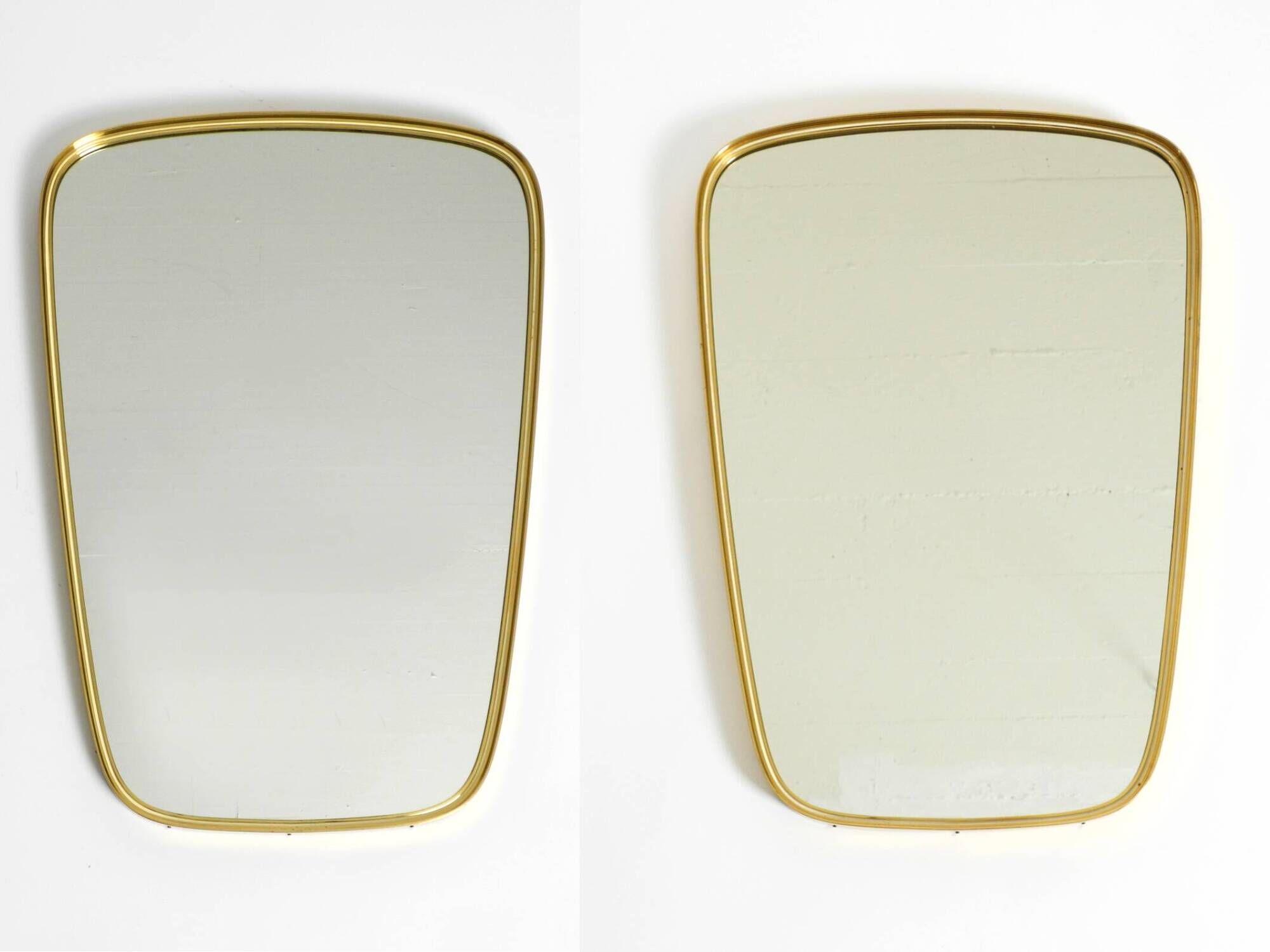 A pair of rare Mid Century "Münchener Zierspiegel" brass wall mirrors