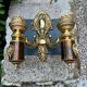 Wall light with 2 branches in baroque brass lion design.