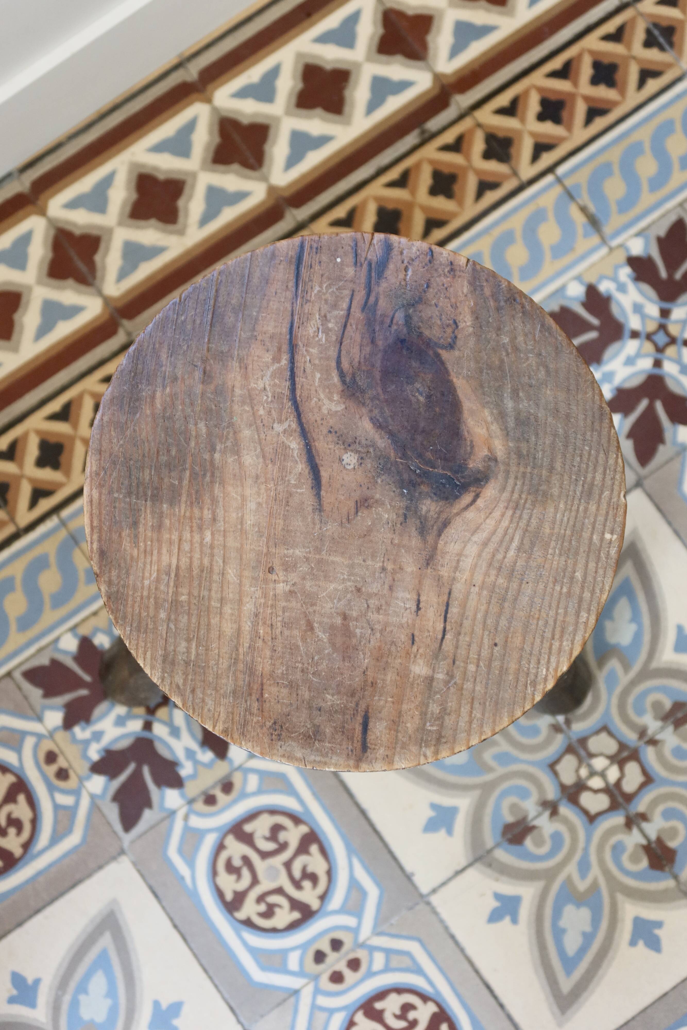 Old dark wood tripod stool