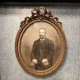 Old ancestor portrait in a gilded oval frame with Louis XVI style knot decoration