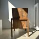 Large armchair in natural wood (teak) with a minimalist design.