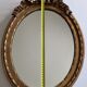 Louis xvi style oval mirror decorated with ribbons