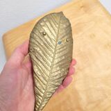 Bronze leaf-shaped pocket emptier