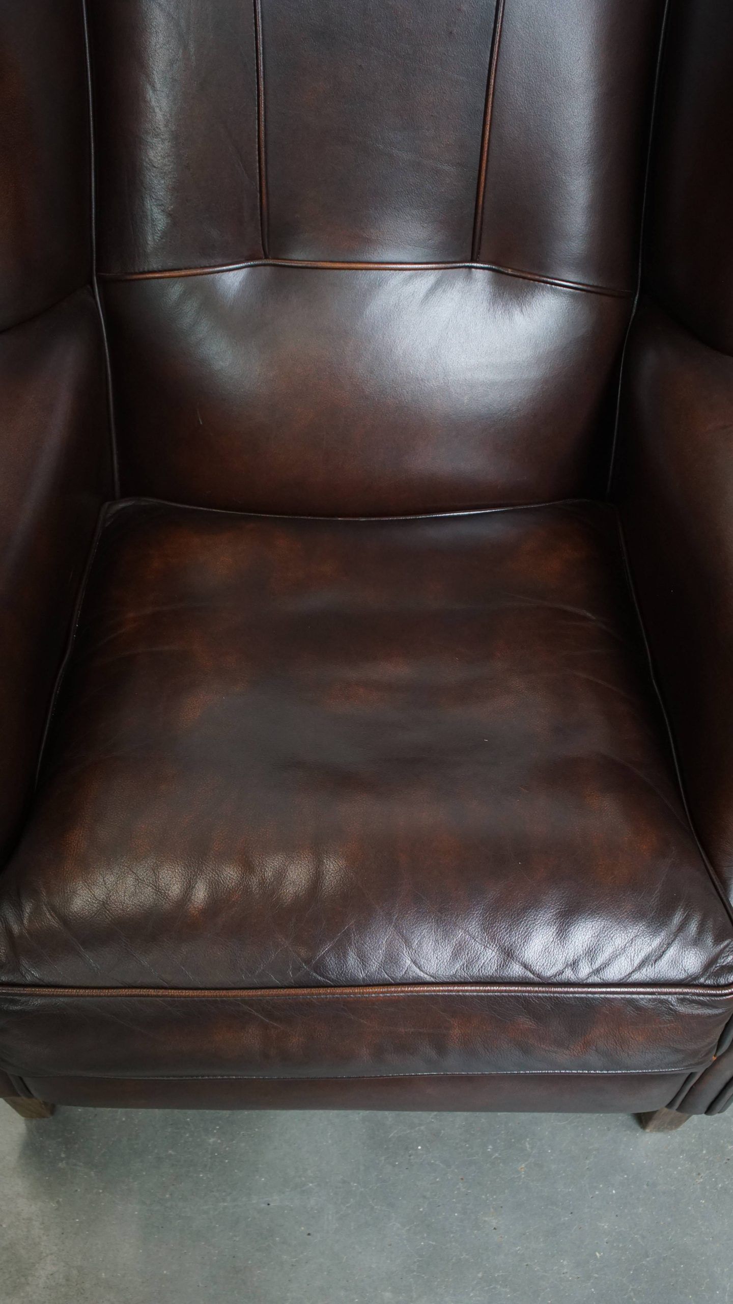 Very beautiful wing chair made of cowhide leather in English style