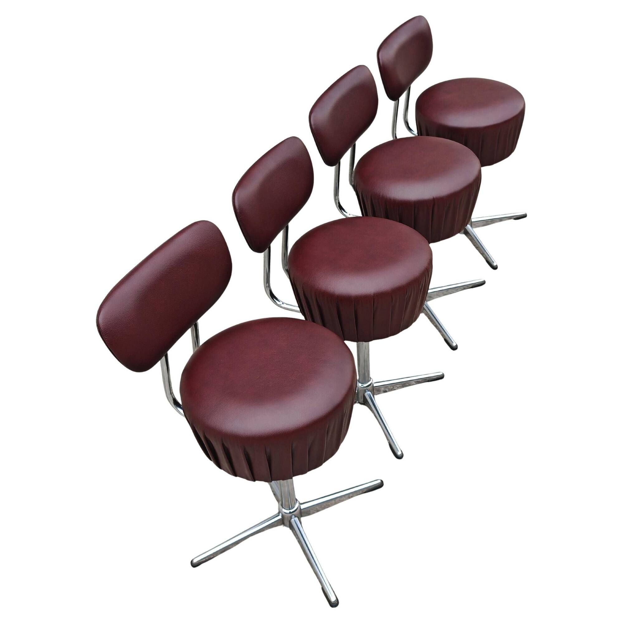 Set of 4 Mid Century Modern swivel chairs in tubular steel and leather.