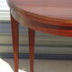 Half-moon console table, extendable in Empire style.
