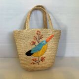 Old woven straw basket embroidered raffia