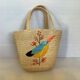 Old woven straw basket embroidered raffia
