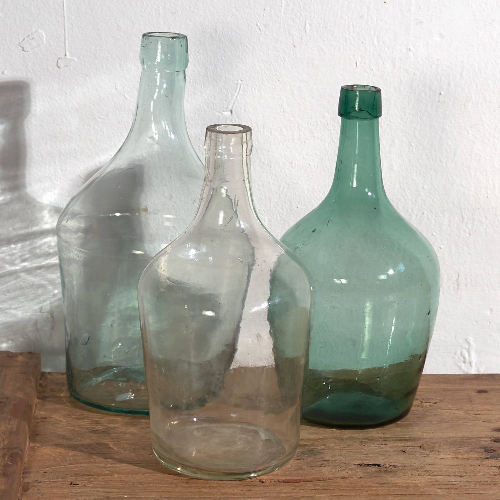Antique colored demijohns (c.1920). Set of 3 pieces