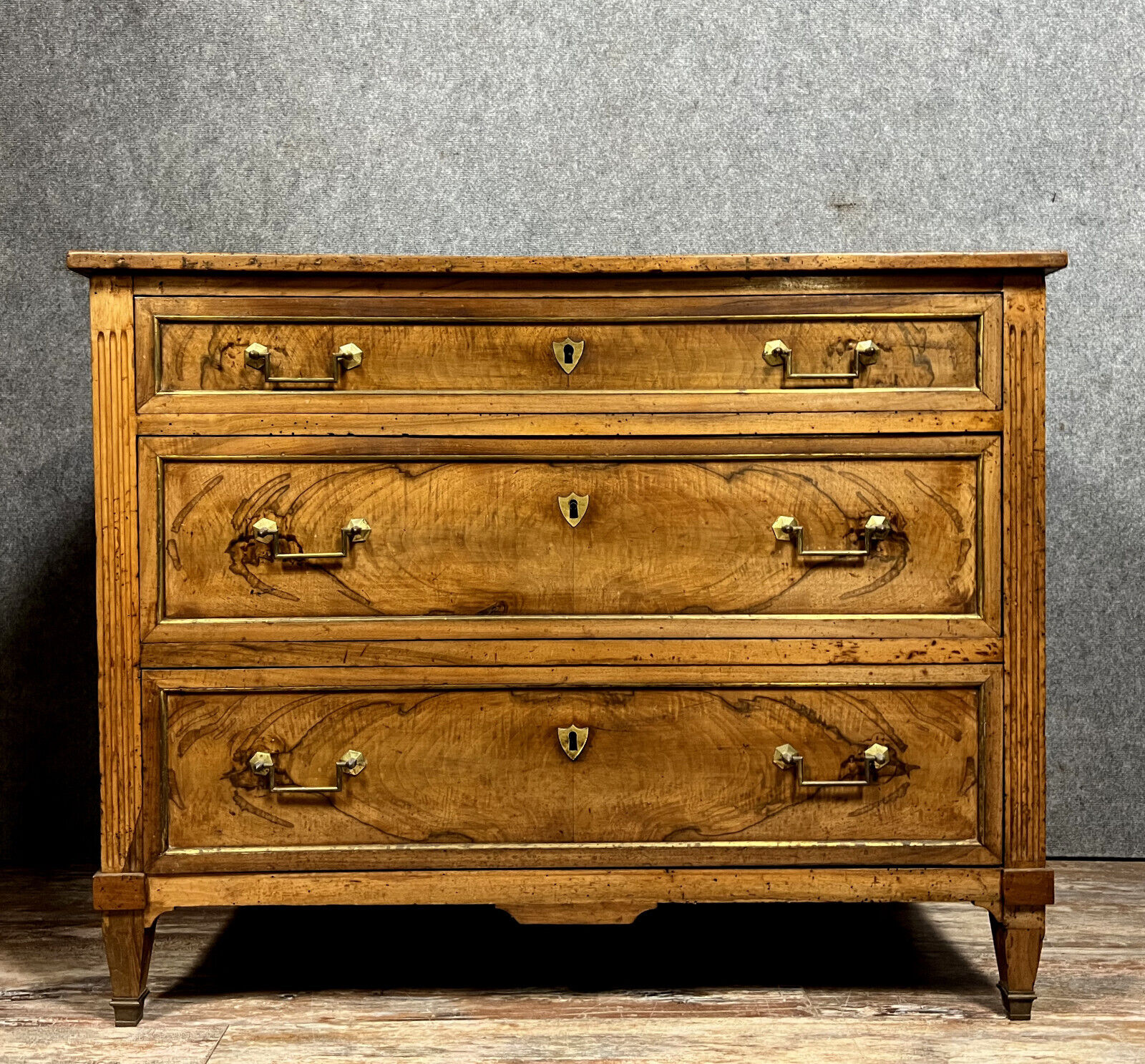 Louis XVI period chest of drawers in walnut and gilded brass nets circa 1780