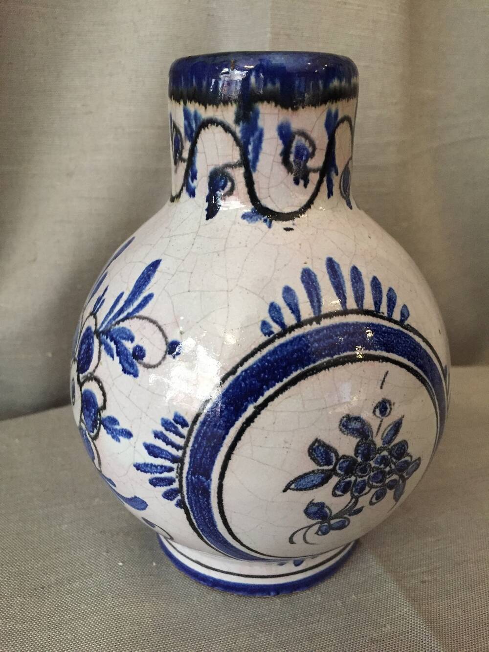 Small white decorative vase with blue floral decoration