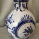Small white decorative vase with blue floral decoration