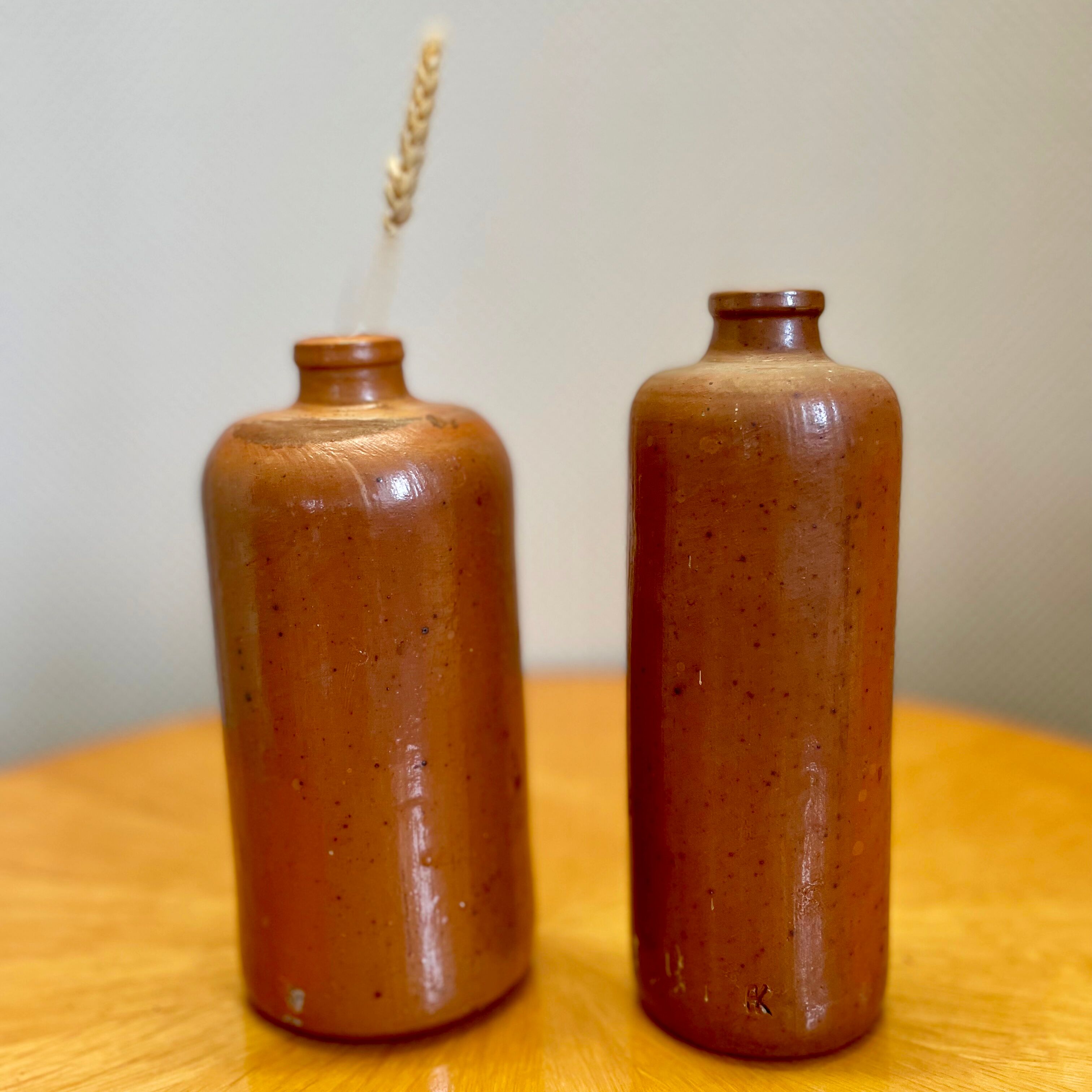 Set of two bottles or jugs in ocher-brown enamelled sandstone