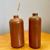 Set of two bottles or jugs in ocher-brown enamelled sandstone