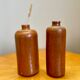 Set of two bottles or jugs in ocher-brown enamelled sandstone