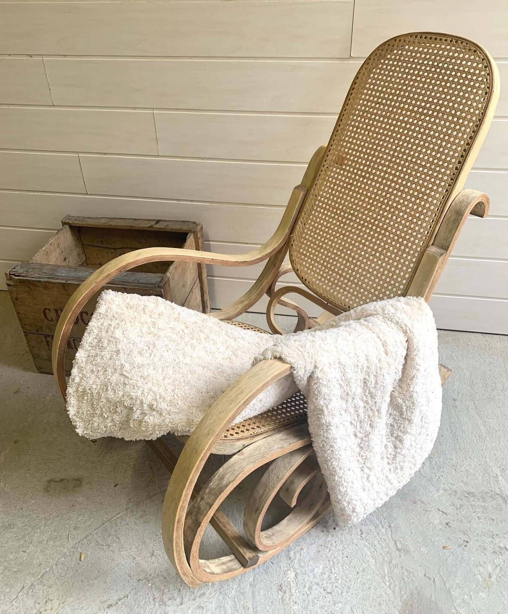 Rocking chair with a cane seat and backrest.