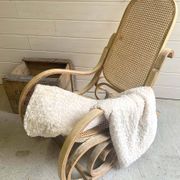 Rocking chair with a cane seat and backrest.