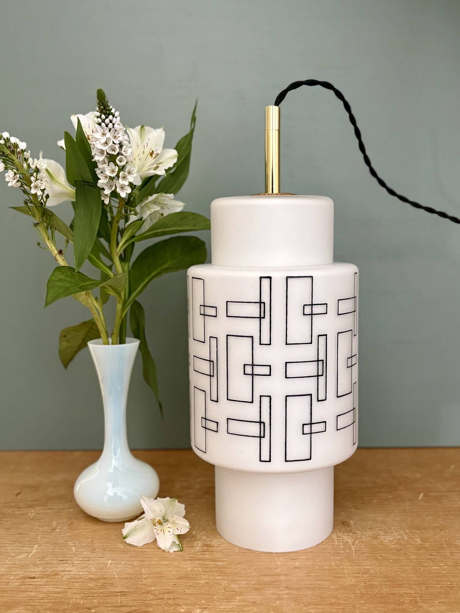 Vintage suspension globe in white opaline with black drawings.