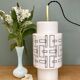 Vintage suspension globe in white opaline with black drawings.
