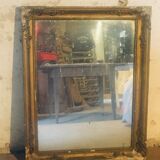 Old mirror with gilded leaves and flowers carved on top of it 1800s