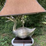 Old vintage lamp representing a duck in silver metal with wooden base