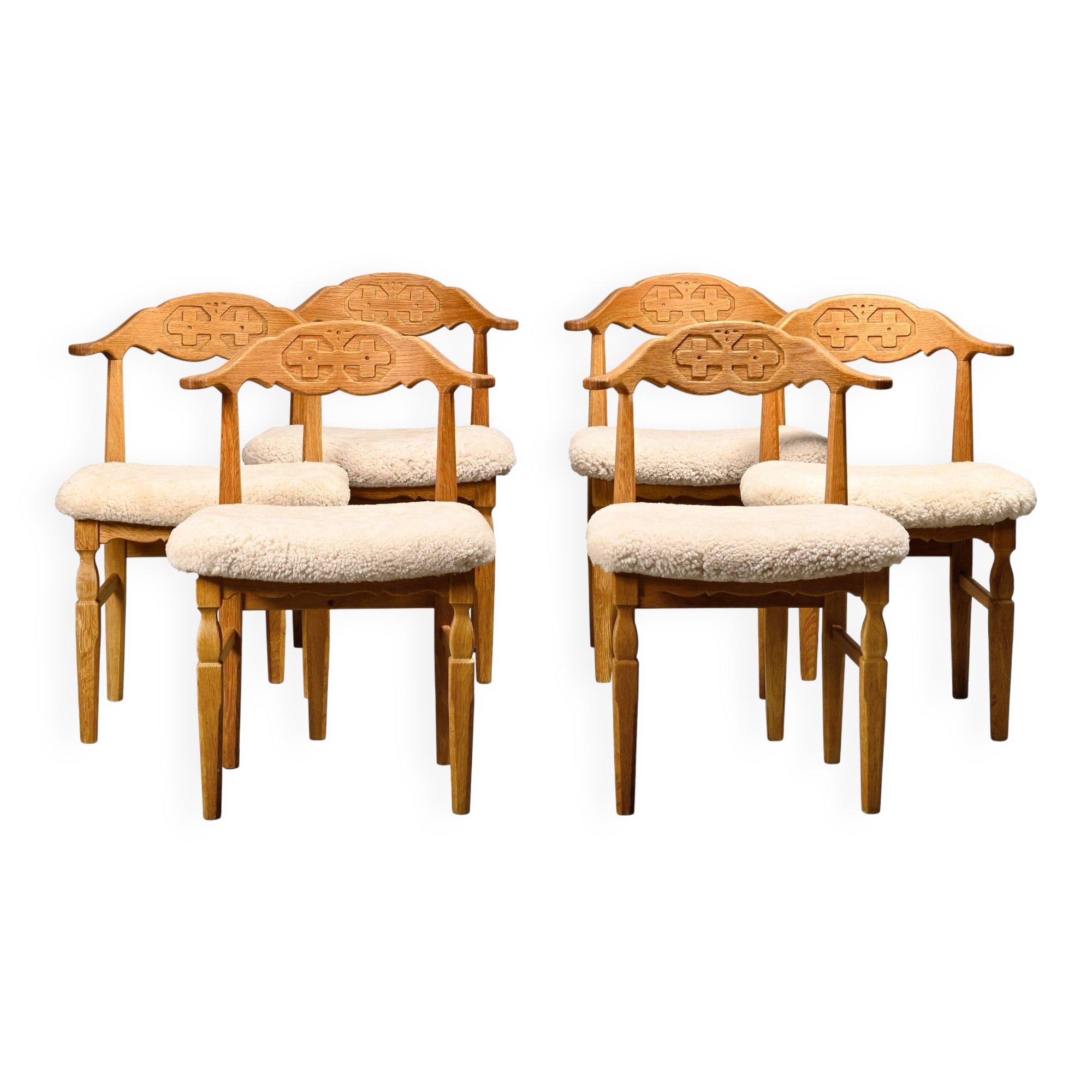 Henning Kjærnulf dining chairs set in Oak and Sheepskin, Denmark, 1960s