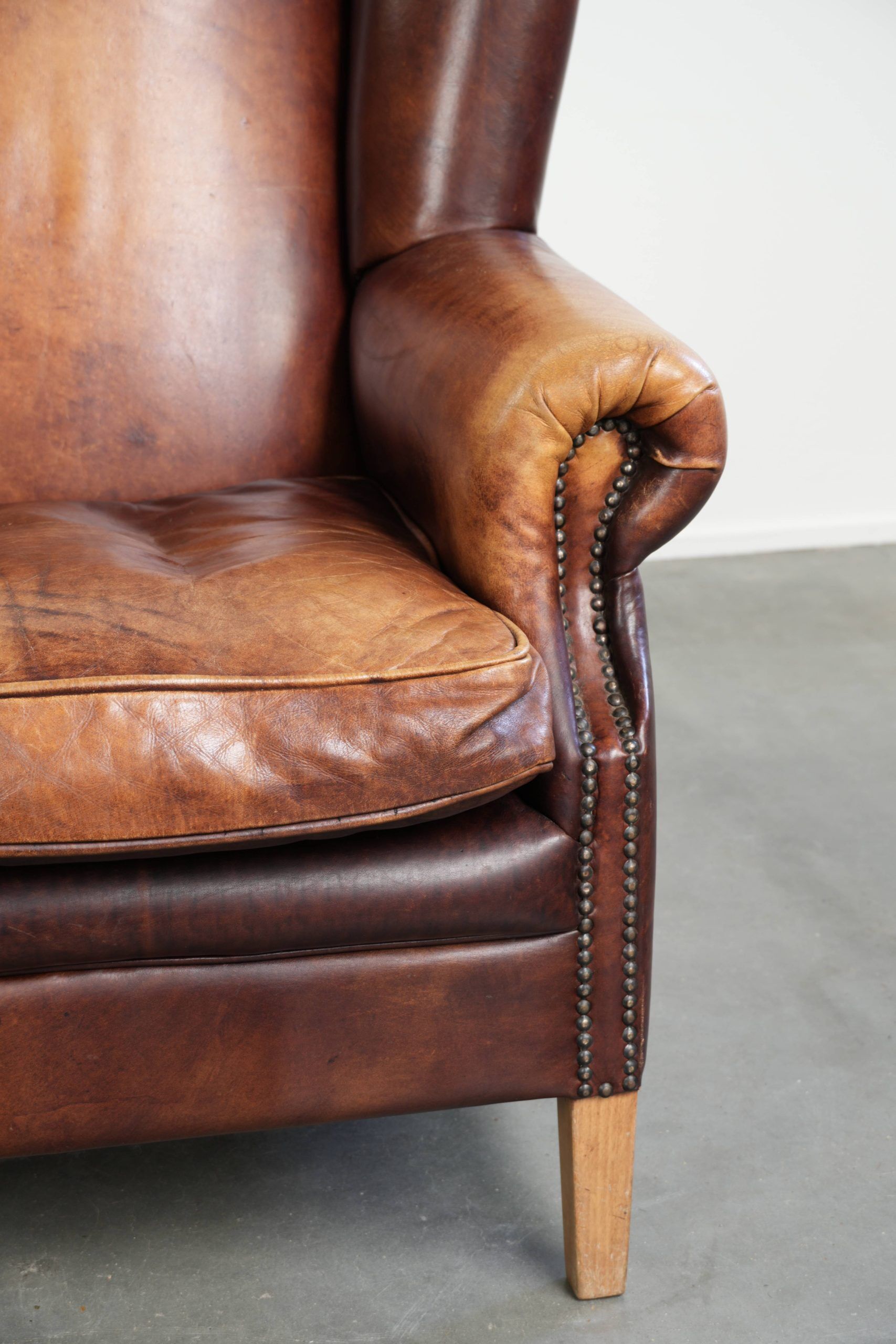 Comfortable cowhide wingback armchair in English style