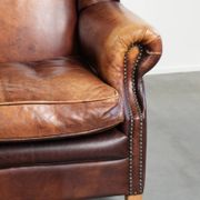 Fauteuil à oreilles en cuir de vache confortable dans le style anglais