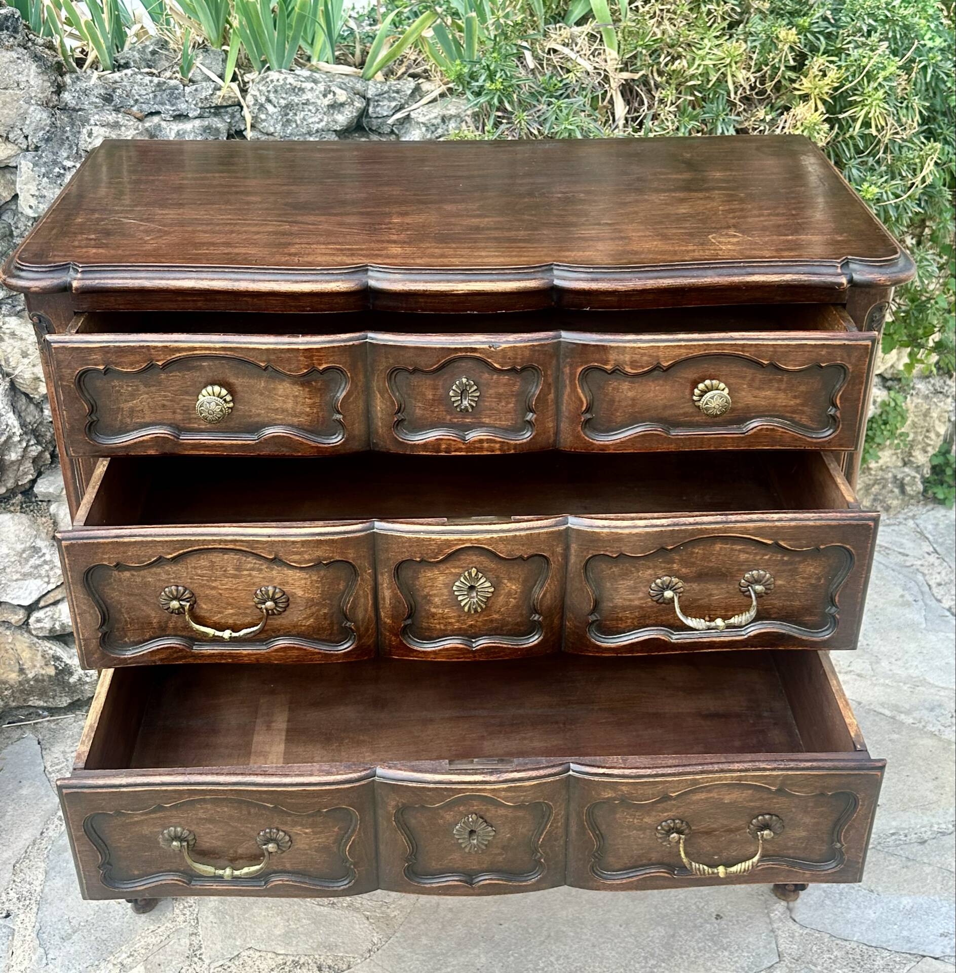 Carved and moulded solid wood commode in the Louis XV style.