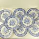 Set de 8 assiettes plates en faïence bleue, décor floral et oiseaux, XXe