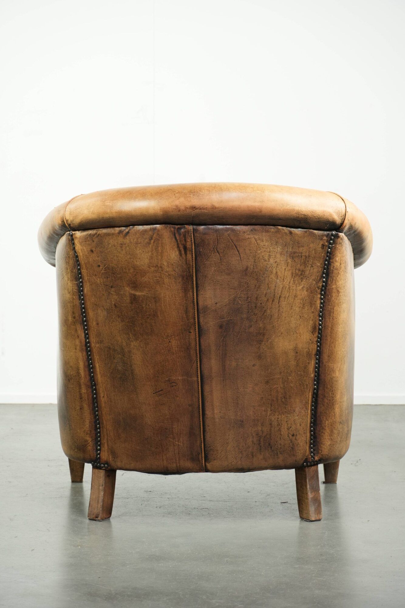 Vintage sheepskin club armchair in a light cognac colour