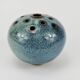 Vase with blue flowers.