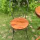 Round table and wrought iron chair