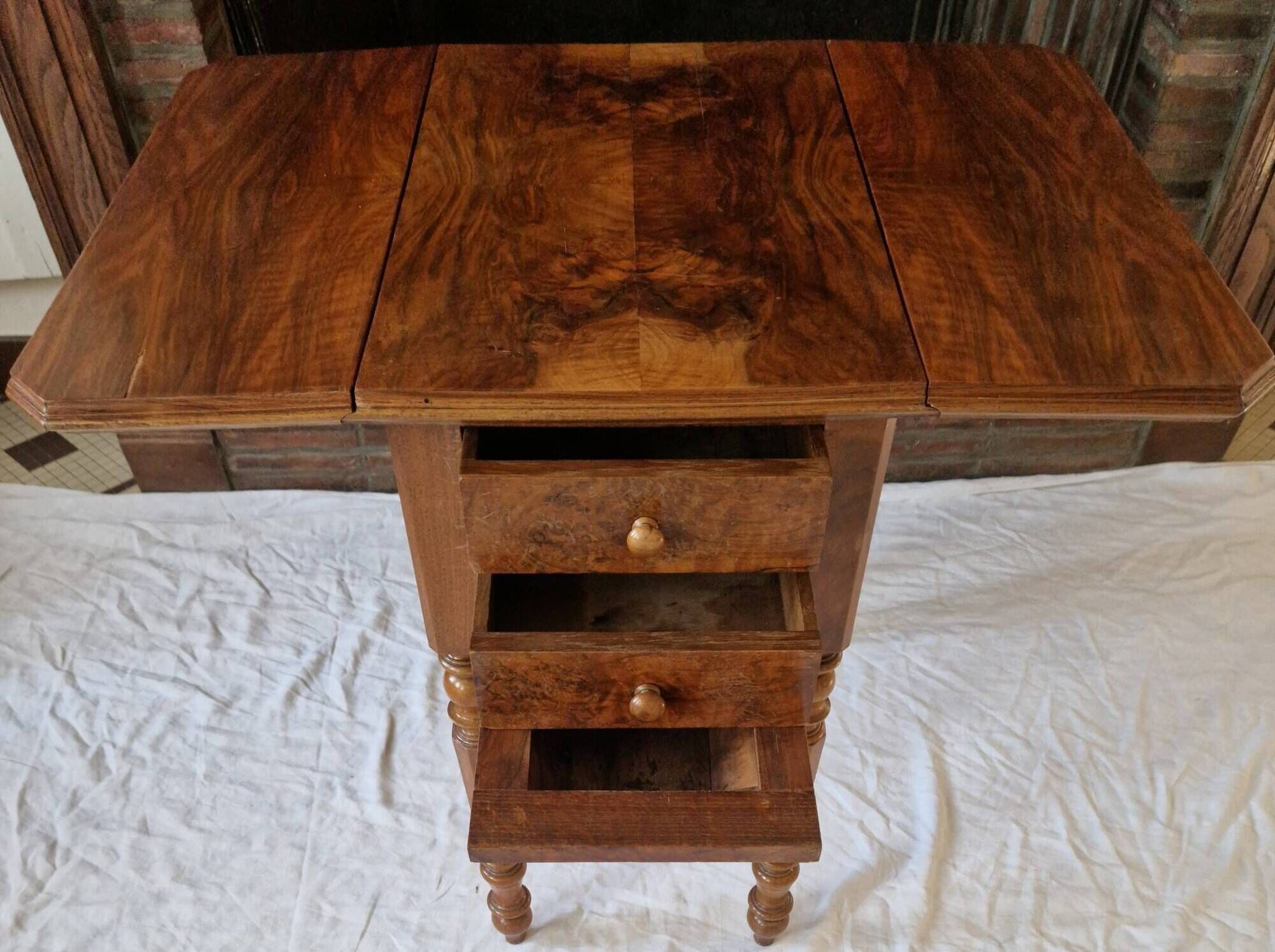 Nineteenth-century walnut work table with flaps, large storage + secret drawer.