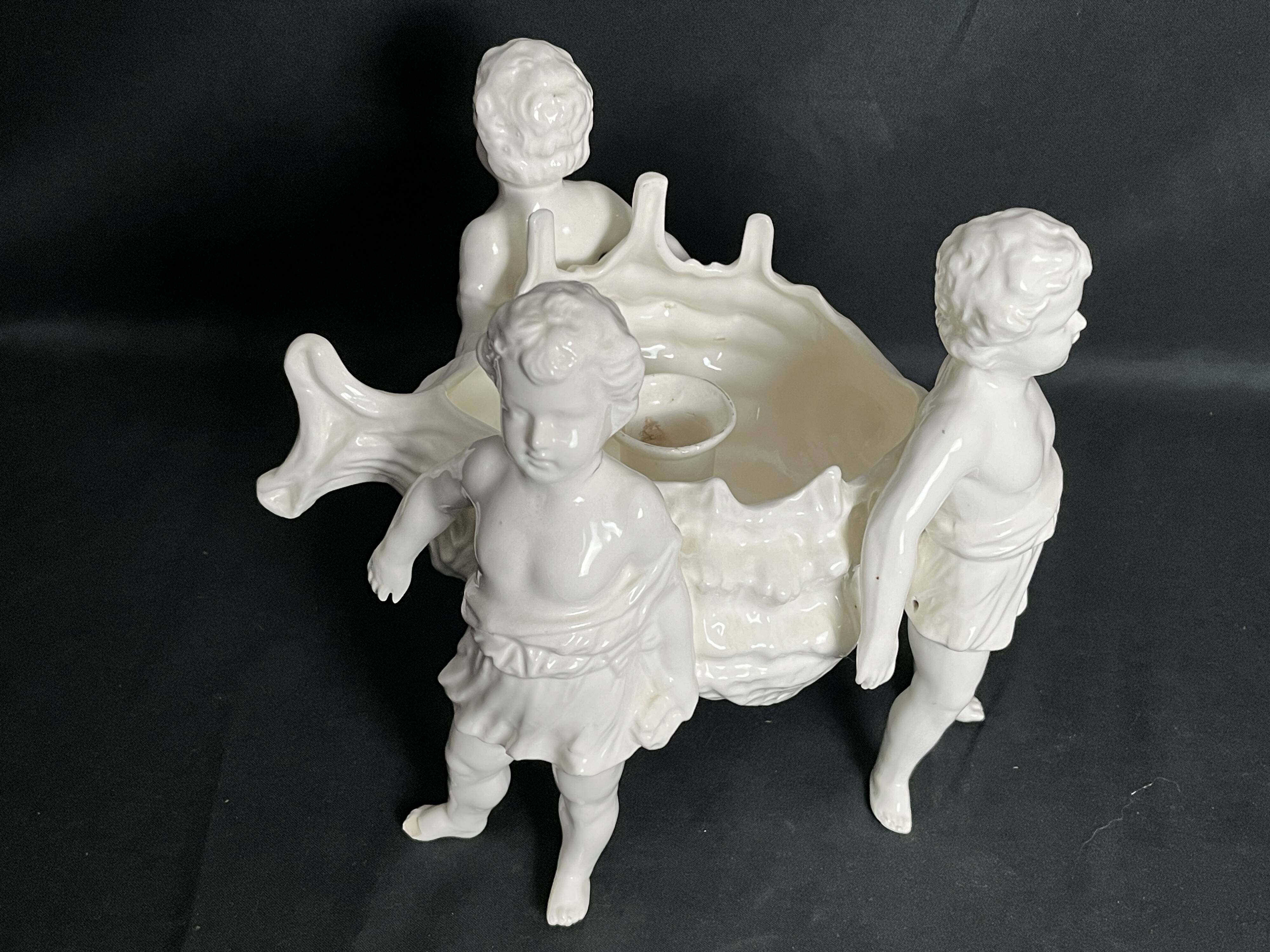 Porcelain, centerpiece with candle holder decorated with putti, 20th century