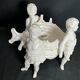 Porcelain, centerpiece with candle holder decorated with putti, 20th century