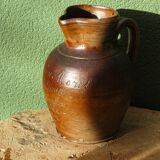 Large stoneware jug with a family name pattern, 1912