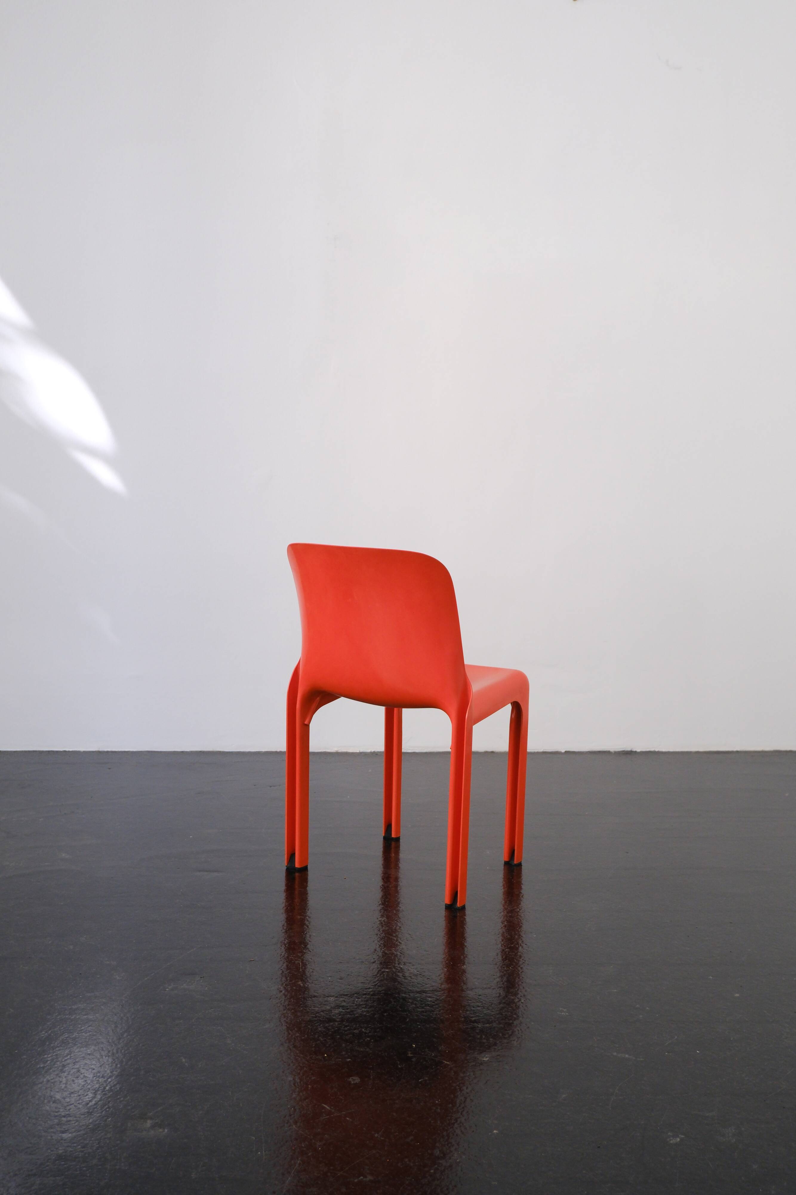 Orange "Selene" chair by Vico Magistretti / Artemide