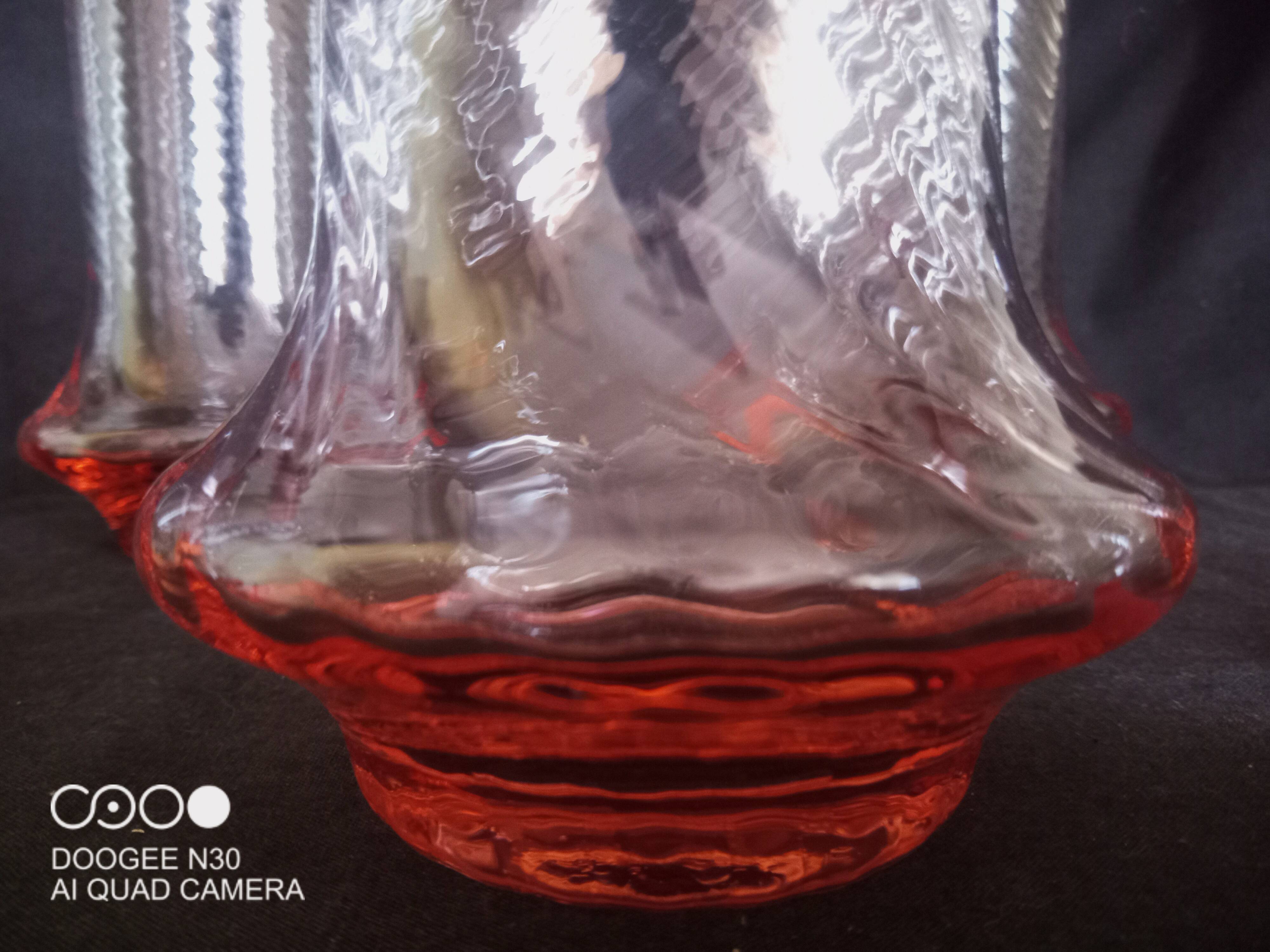 Art Deco orangeade service in pink-orange glass, twisted model.